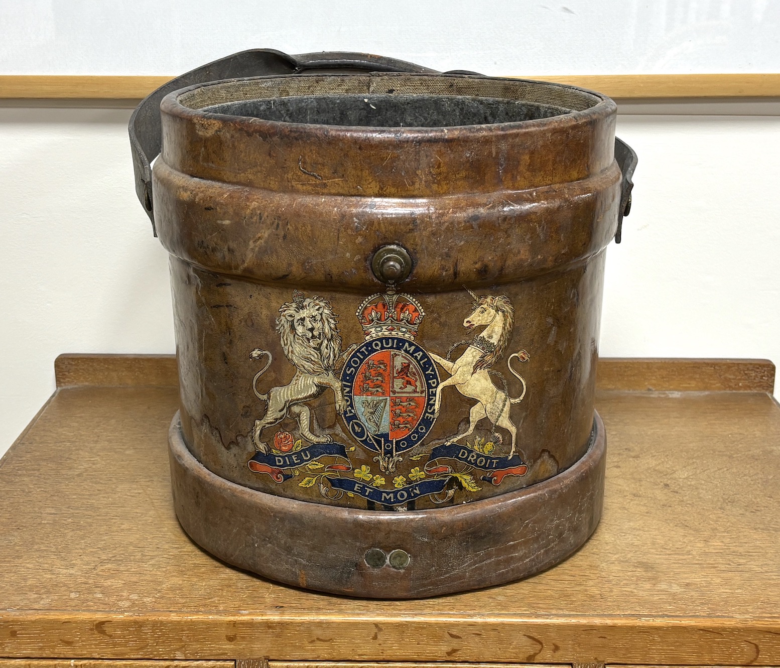 A Victorian tan leather shot carrier with applied royal crest and tin liner, diameter 35cm, height 34cm